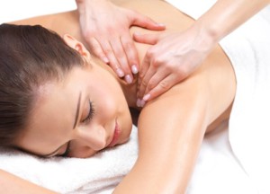 Beautiful woman getting a massage - Portrait of a pretty young girl getting a massage at the day spa